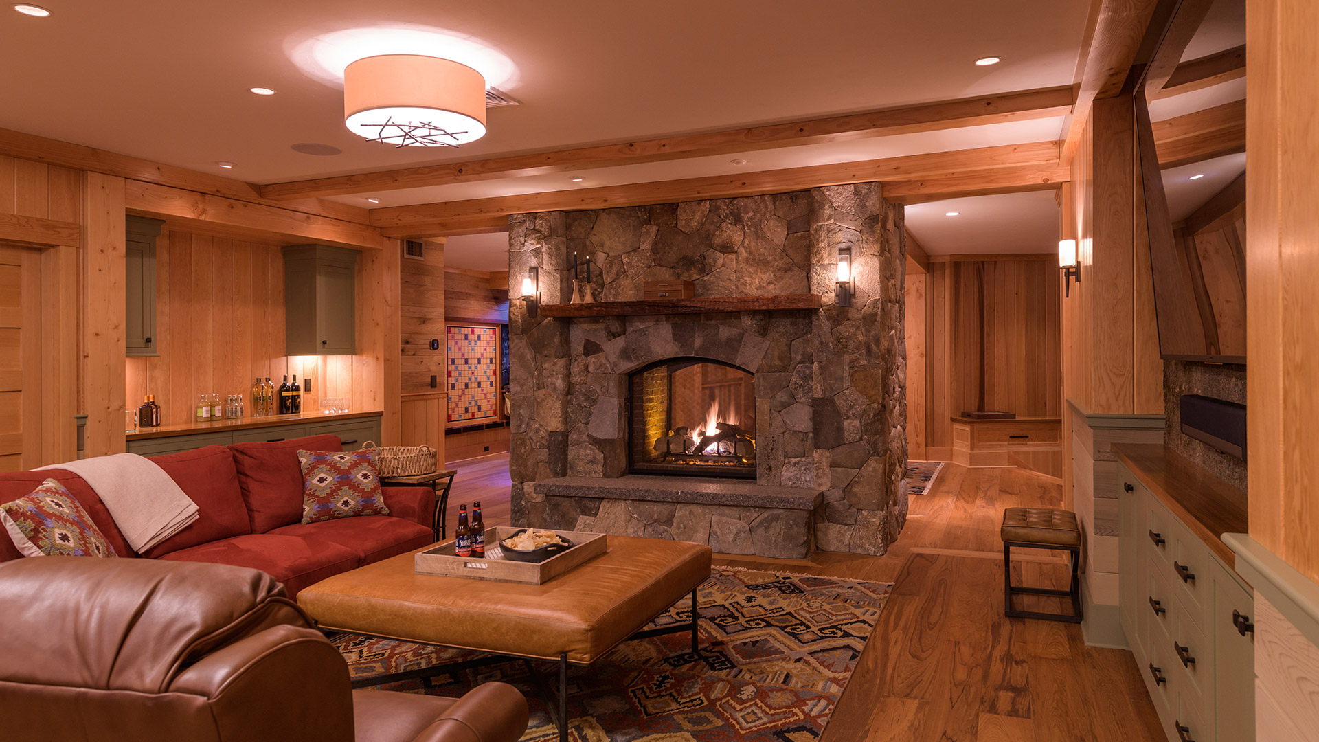 Alton, New Hampshire game room with see-thru stone fireplace