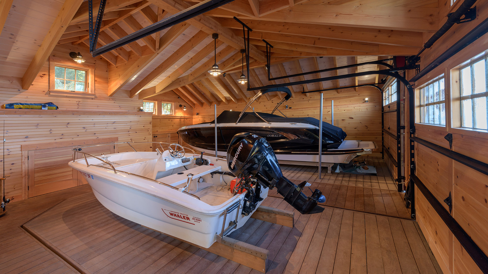 Alton New Hampshire Boathouse interior view of the boathouse with vaulted timber roof and boat lifts.
