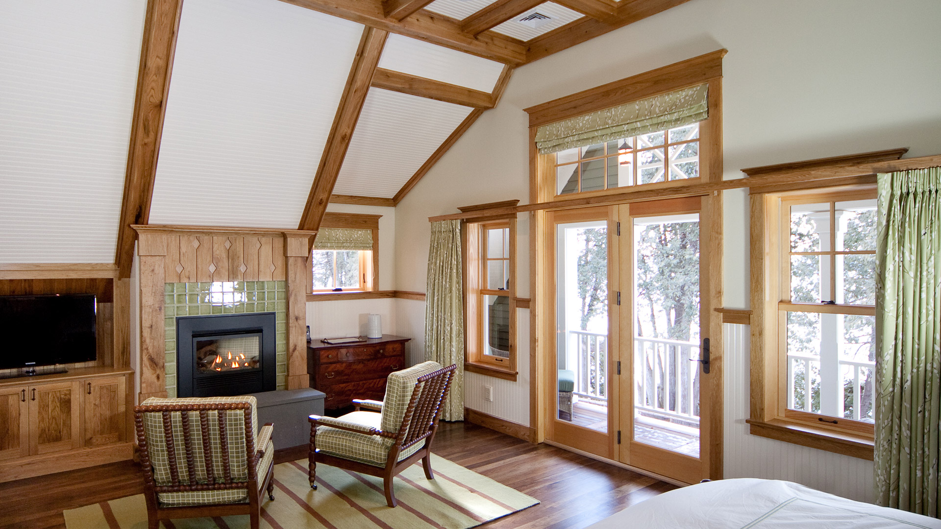 Lake Champlain Vermont master bedroom with vaulted ceiling and fireplace