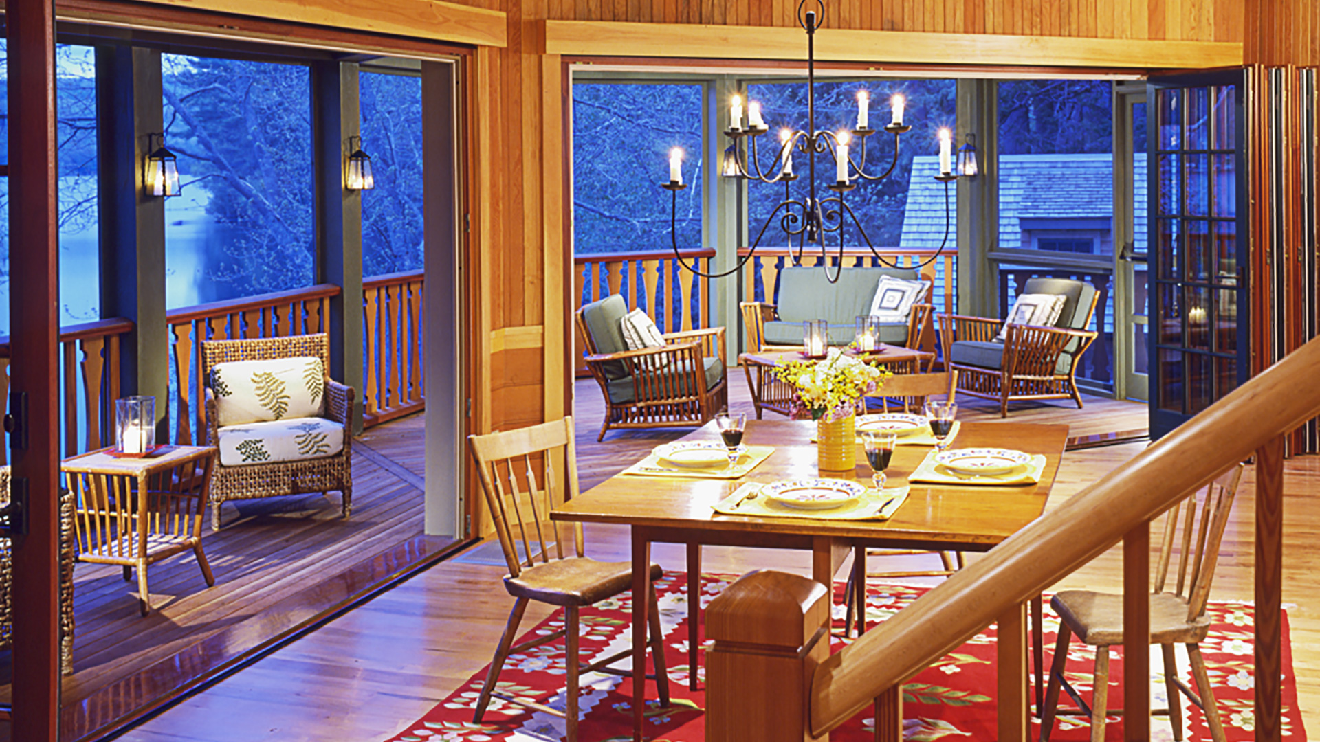 Silver Lake, New Hampshire rustic dining room with large bifold doors too screen porch